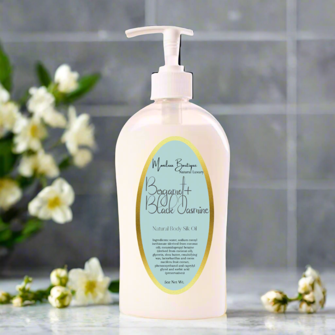 bottle of body wash sitting on a bathroom counter with jasmine flowers in the background