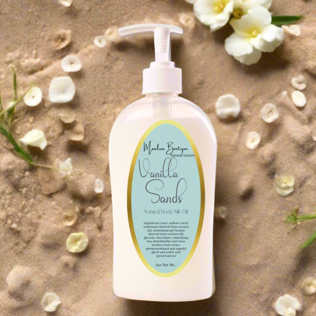 flat lay of a body wash bottle on white sand with white flowers